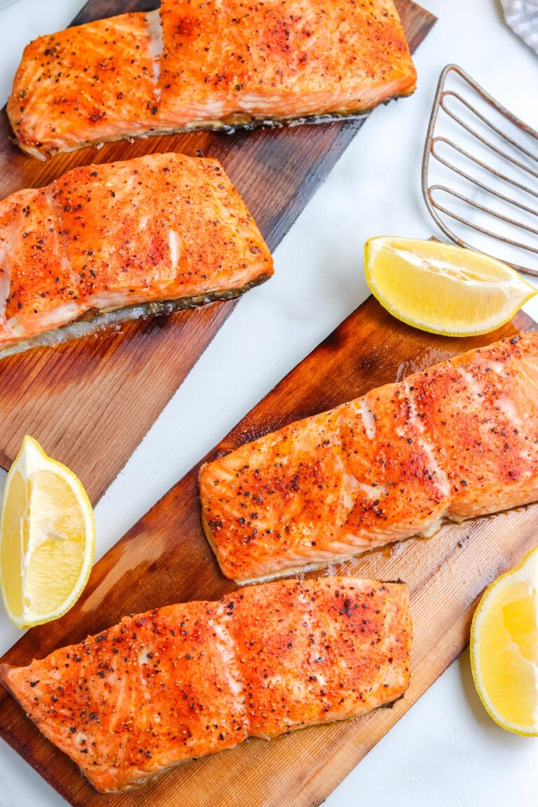 An overhead picture of four grilled cedar plank salmon filets.