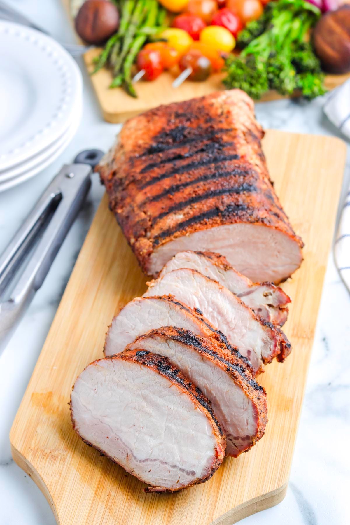 The grilled pork loin roast cut into slices.