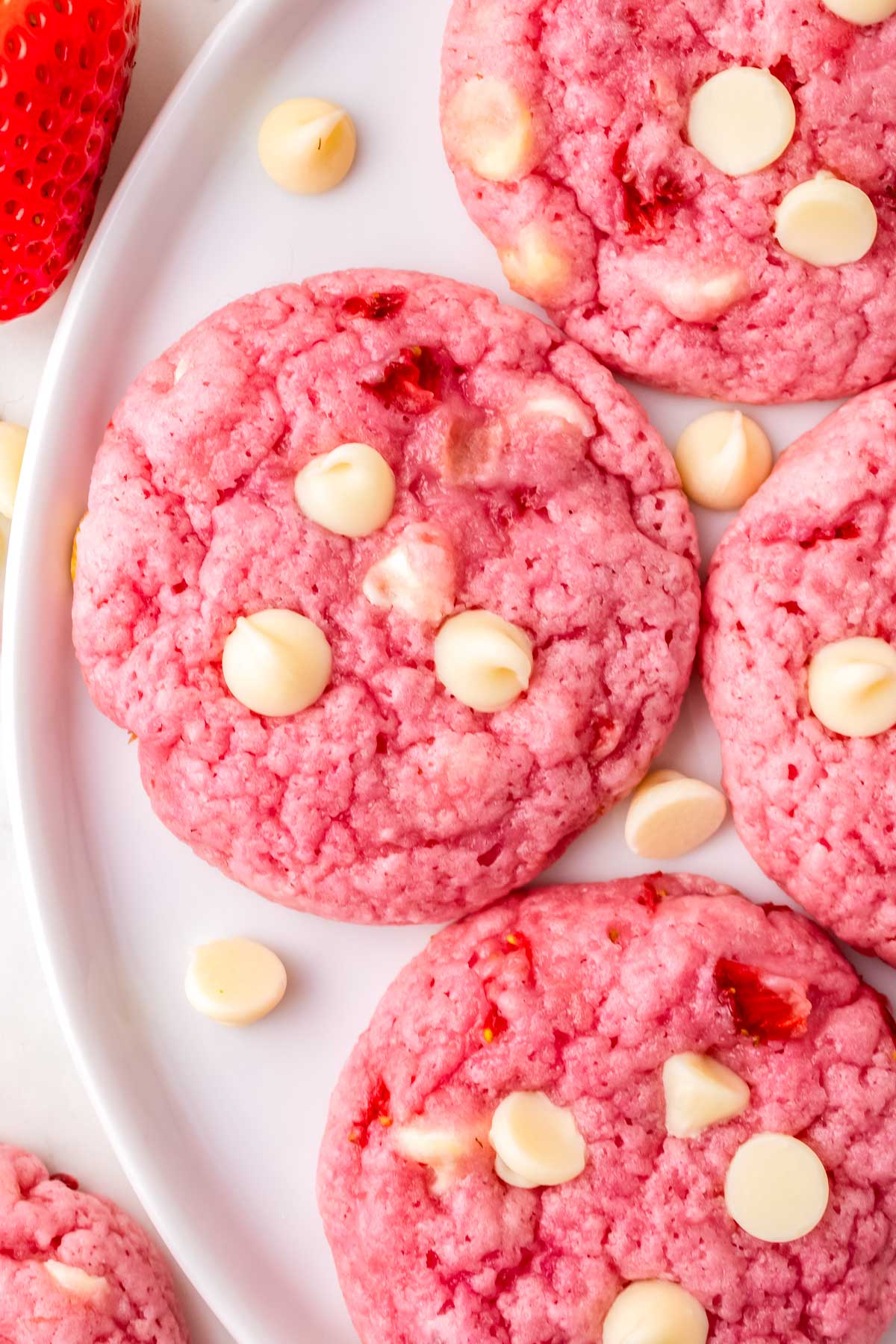 Strawberry White Chocolate Chip Cookies on a white serving plate.