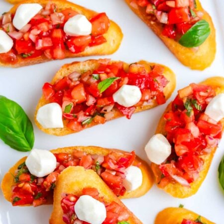 The finished Bruschetta with Mozzarella recipe on a white platter.