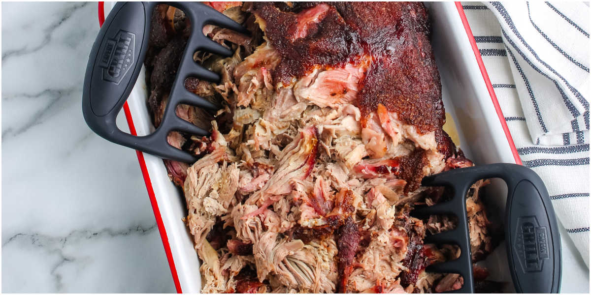 Smoked pork butt being pulled into pieces.