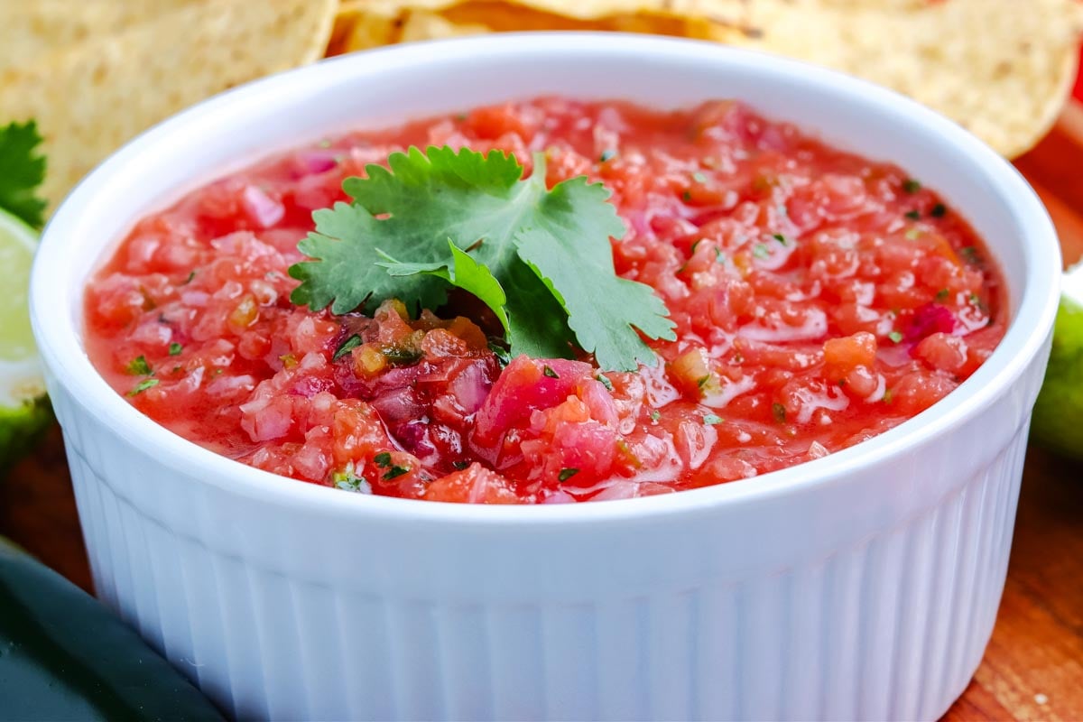 Traeger Smoked Salsa in a white serving bowl and garnished with fresh cilanto.