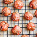 The finished smoked meatballs on a wire rack after they've been pulled from the Traeger smoker.