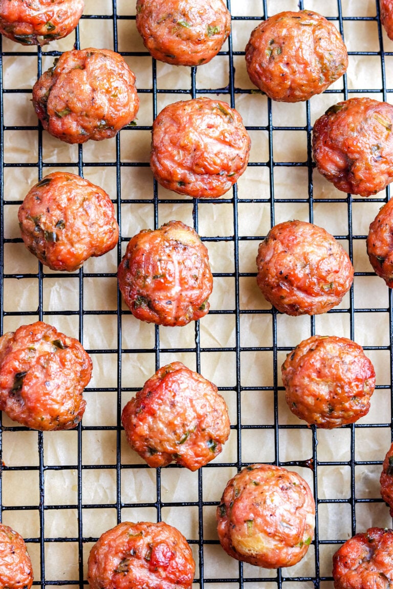 The finished smoked meatballs on a wire rack after they've been pulled from the Traeger smoker.