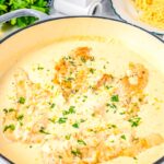 Creamy lemon chicken cooking in a skillet with parmesan cream sauce