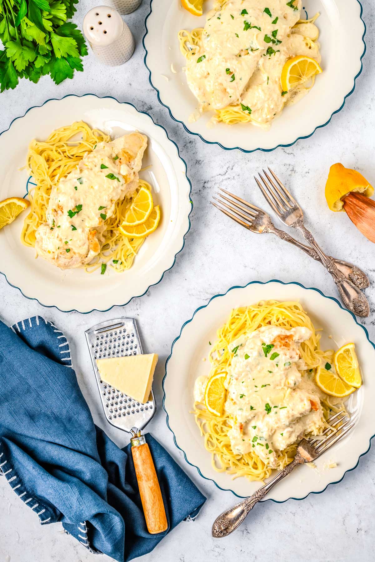 Close up of creamy lemon chicken with parmesan cream sauce and fresh lemon slices