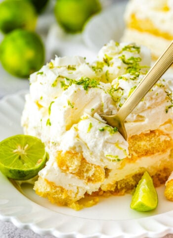 Plated slice showing creamy layers and lime garnish.