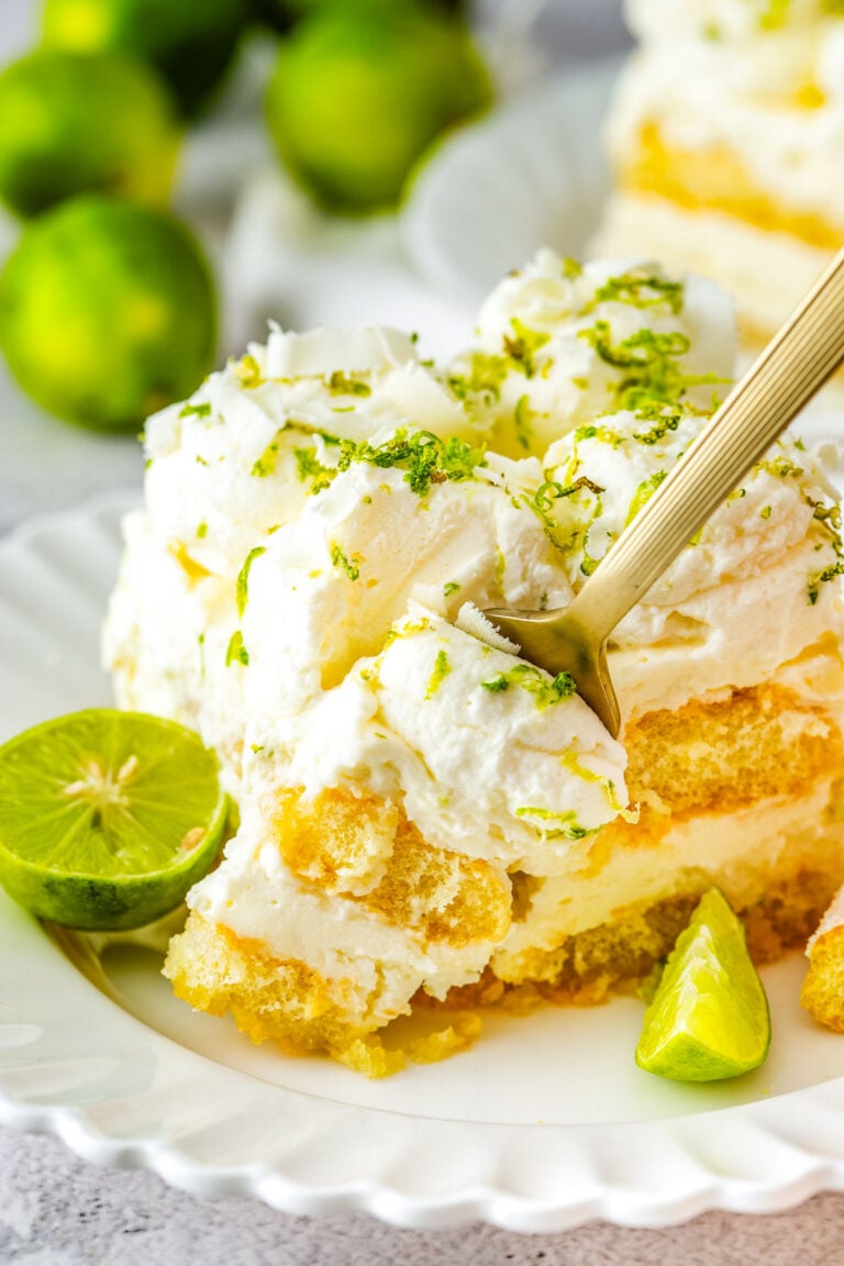 Plated slice showing creamy layers and lime garnish.