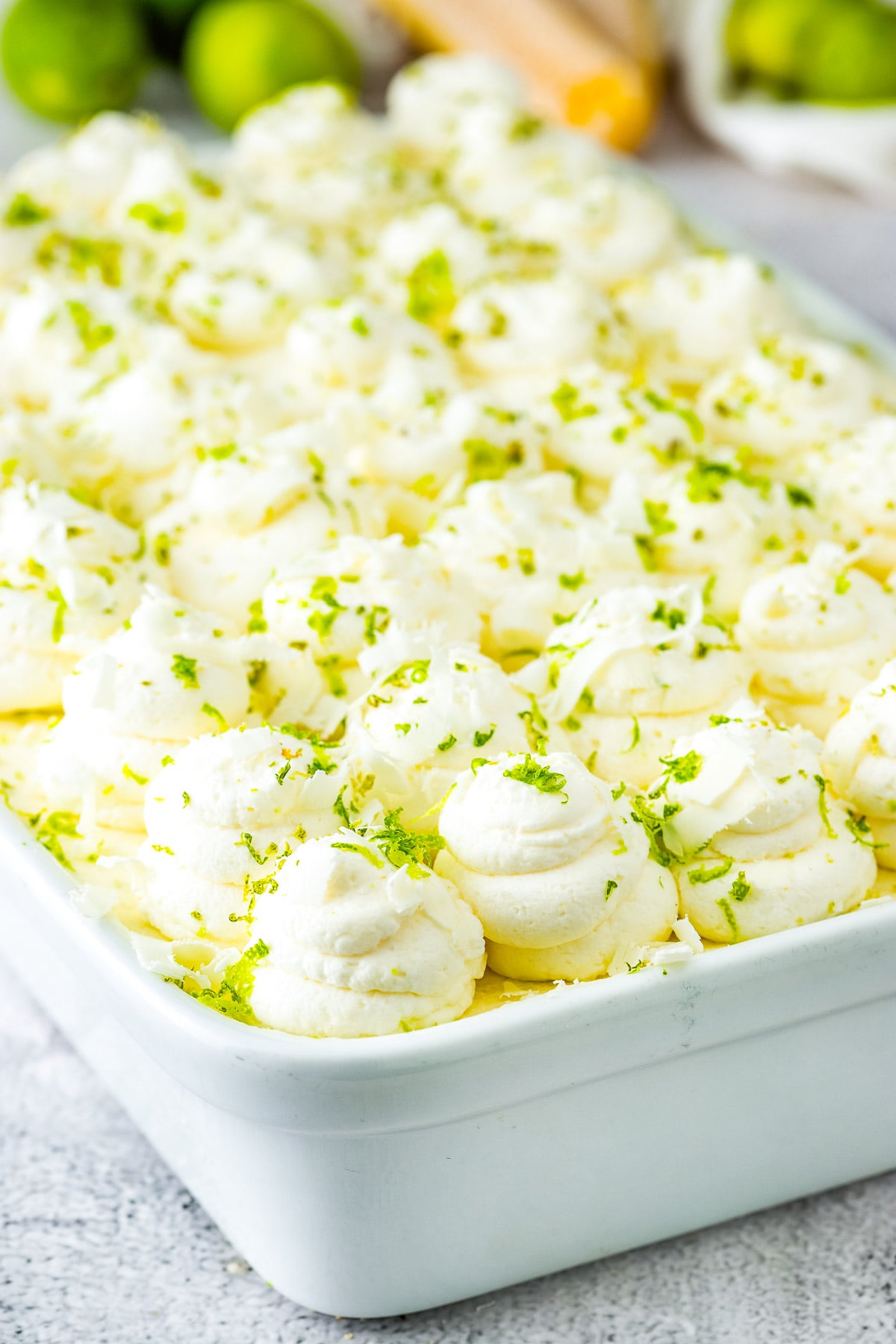 Full pan of key lime tiramisu with piped whipped cream topping.
