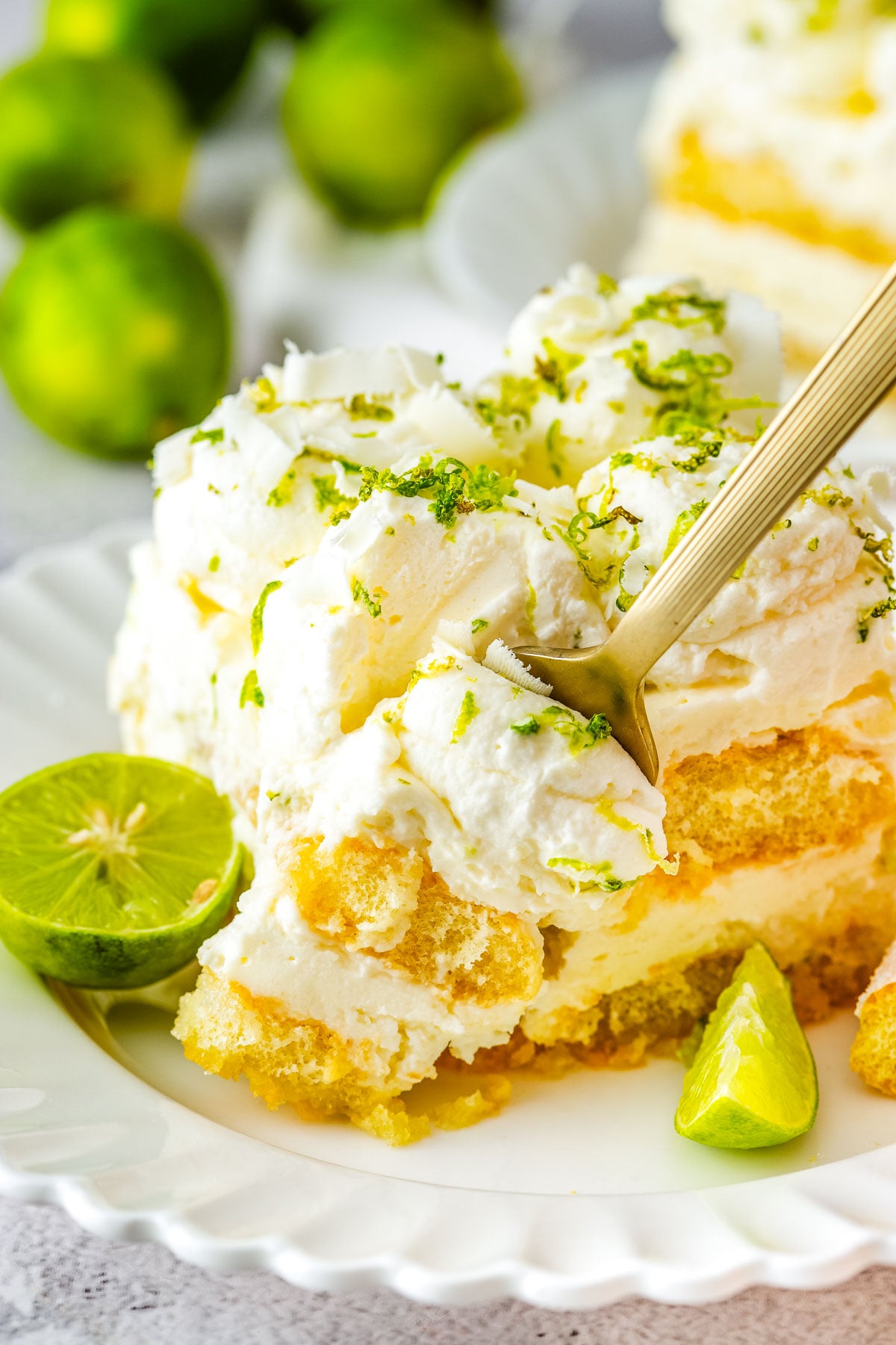 Plated slice showing creamy layers and lime garnish.